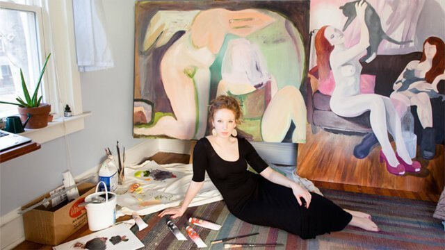 Jessica Thim poses with paintings in her room