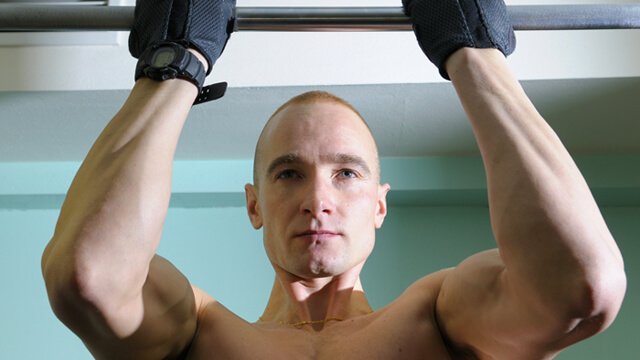 Man completing a chin-up