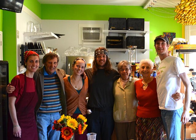 Arnold's Way community members pose for a photograph with the Nucleus Raw Foods crew in April 2014