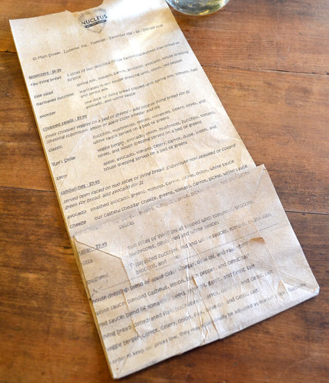 A menu printed on a paper bag at Nucleus Raw Foods