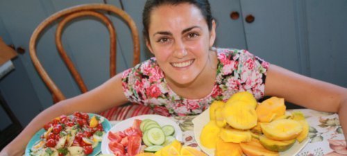 Jesi DiPalo surrounded by fruits on a kitchen table