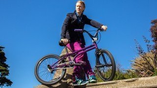 Timothy Radley looks into the distance beside his BMX bicycle
