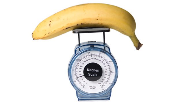 Weighing a banana on a kitchen scale