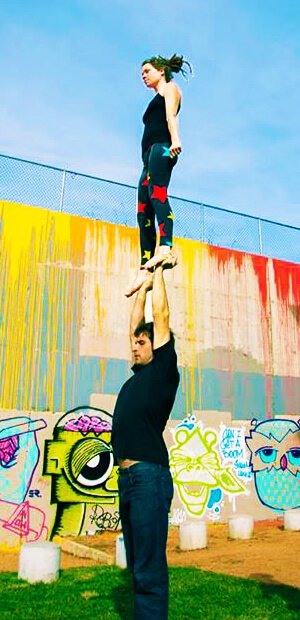 Brittany Taylor stands on Noah while practicing acroyoga