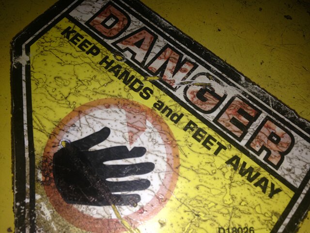 A danger sign adhered to a lawnmower
