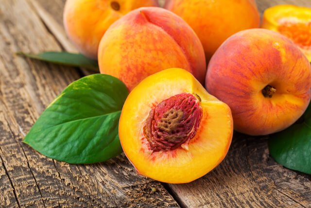 Peaches on wood background