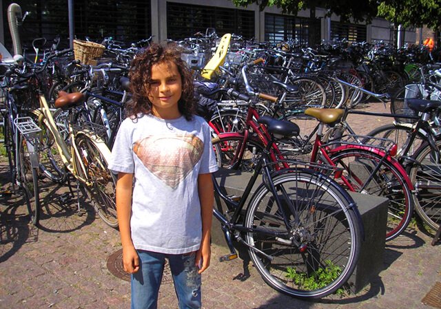 Cappi Osborne is photographed with scores of bicycles in Denmark