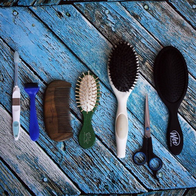 Vegan brushes and combs on wooden planks