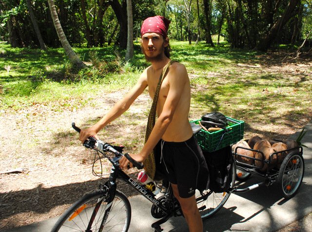 Mads Gisele Johnsen on a bicycle with coconuts
