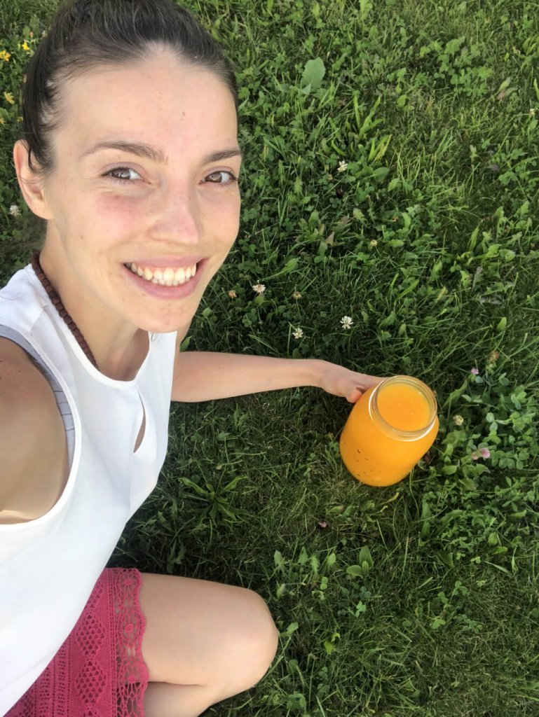 Kristina Poudyal - on juice fast - relaxing on grass - Fruit-Powered